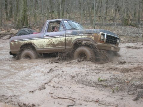 1996 Ford Bronco - Ford Bronco navigating a challenging muddy off-road course.