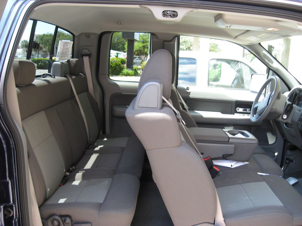 2006 Ford F-150 interior showing front seats, dashboard, and rear bench seat