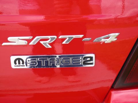 1997 Ford Probe - The SRT-4 and Stage 2 Mopar badges are visible on the red exterior of the vehicle.