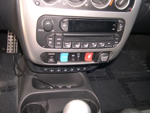 1997 Ford Probe - Interior view of a car's dashboard, showing the center console with audio controls and a power outlet.