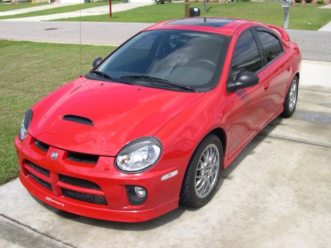 1997 Ford Probe - This red Dodge Neon SRT-4 features a distinctive hood scoop and a rear spoiler.