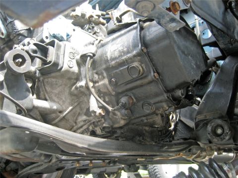 1993 Ford Probe - Close-up of a vehicle's undercarriage, focusing on the transmission and suspension system.