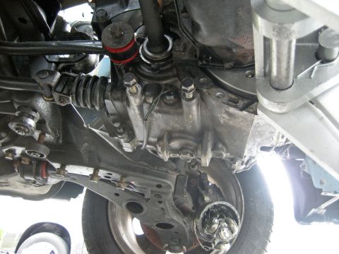 1993 Ford Probe - Close-up view of the undercarriage, highlighting the transmission and suspension system components.