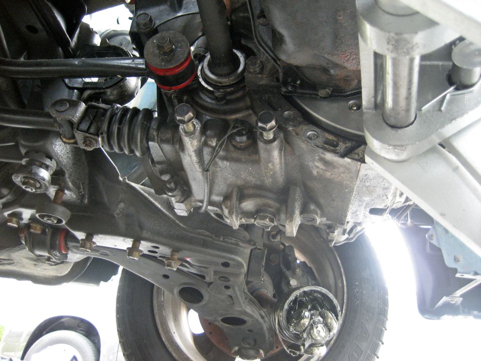 Vehicle underbody with transmission and suspension parts visible