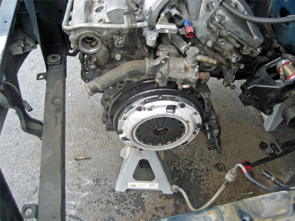 Engine and transmission assembly on jack stands, showing clutch and engine block