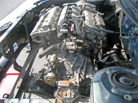 1993 Ford Probe - The engine and transmission are exposed in the car's engine bay, with various hoses and components visible.