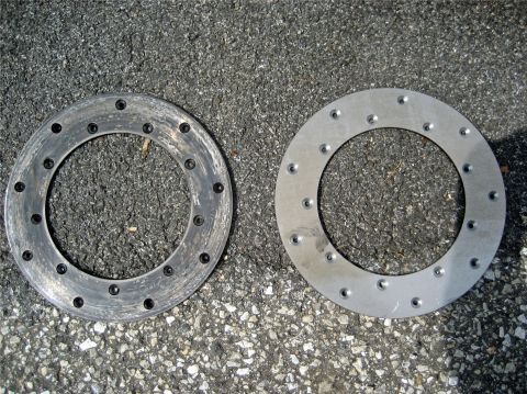 1993 Ford Probe - Comparison of a worn brake rotor next to a new one, both with multiple bolt holes.