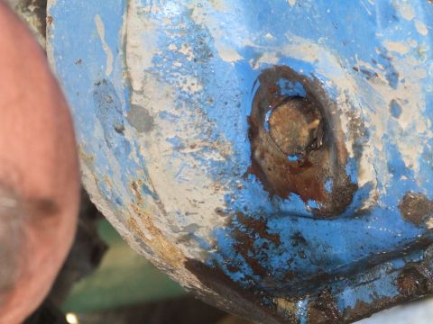 1969 Ford Bronco - A heavily rusted metal part, painted blue, shows significant wear and tear.