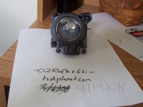 1993 Ford Probe - A single automotive headlight assembly is shown on a piece of paper with handwritten notes and a website logo.