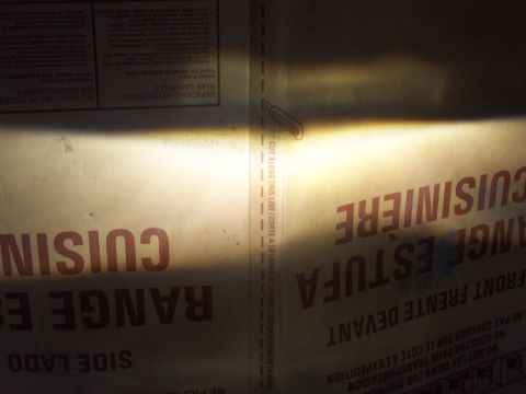 1993 Ford Probe - A bright headlight beam illuminates text on a cardboard box, likely packaging for a kitchen appliance.