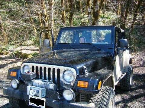 2005 Jeep Wrangler - A black 2005 Jeep Wrangler is parked off-road, a winch and a custom front bumper.