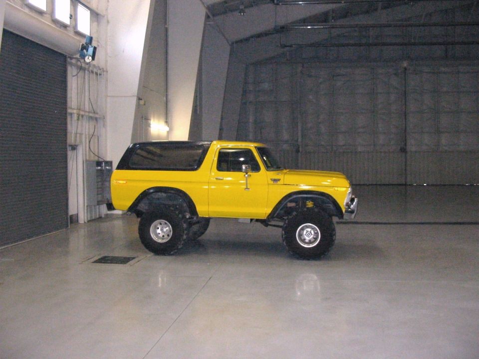 Yellow lifted 1979 Ford Bronco side view with large tires