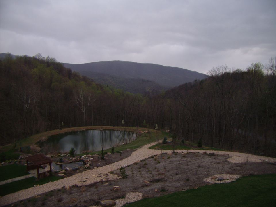 Mountain landscape with a pond and gazebo