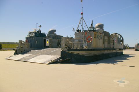 1986 Ford Bronco - Two Landing Craft Air Cushion vehicles are parked on a paved surface under a clear blue sky. One vehicle, labeled LCAC-16, is in the foregr…