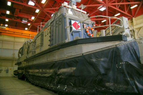 1986 Ford Bronco - A hovercraft with the designation LCAC-519 is parked indoors, showing its skirt and upper cabin structure.