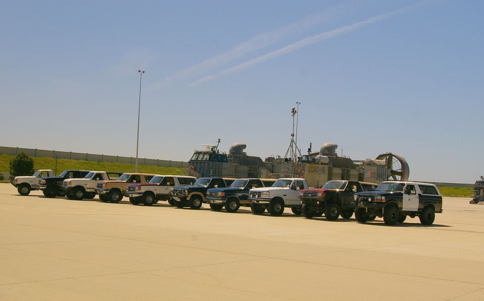 Line of Ford trucks and Broncos parked in front of hovercrafts