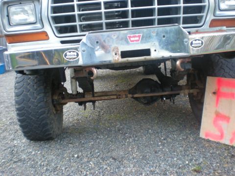 1993 Ford Bronco - Front view of a 1979 truck, a chrome bumper with a Warn winch mount and large off-road tires.