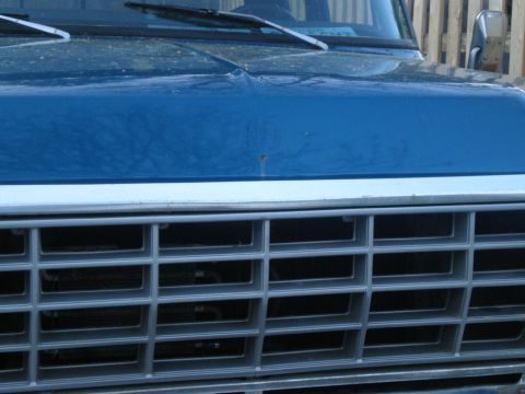 1993 Ford Bronco - Front view of a blue truck, focusing on the grille and hood details.