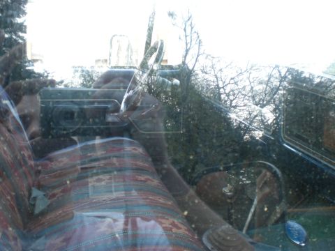 1993 Ford Bronco - View from inside a vehicle, showing patterned upholstery and a reflection of the photographer.