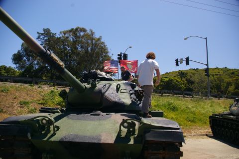 1986 Ford Bronco - A tank with "PUNISHER" written on its barrel is seen with American and Marine Corps flags in the background.