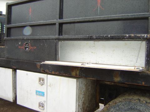 1992 Ford Bronco - Utility body on a truck shows multiple storage compartments, one with an open door.