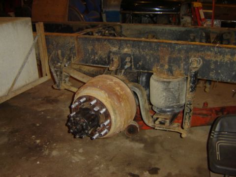 1992 Ford Bronco - Close-up view of a rusty rear axle drum brake and air suspension system, likely from a heavy-duty truck or trailer.