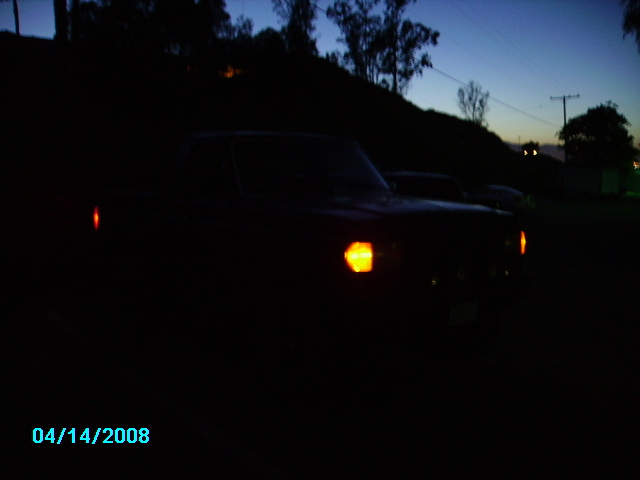 Truck silhouette with headlights on at dusk. Date stamp 04/14/2008