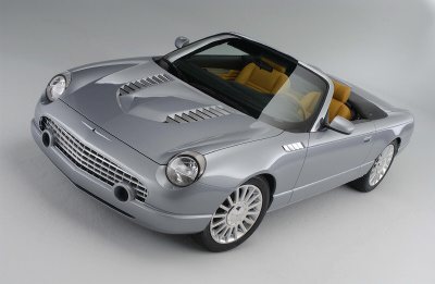 2004 Ford Thunderbird - A silver convertible with a tan interior is shown from a three-quarter front angle against a neutral background.