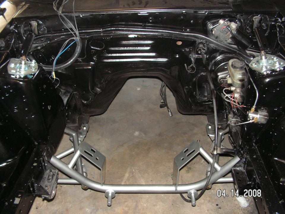 Engine bay with aftermarket subframe connectors and brake master cylinder