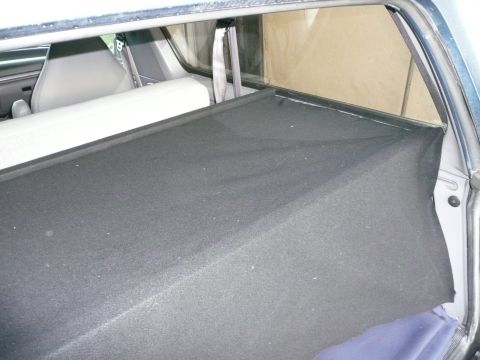 1991 Ford Bronco - The interior of a 1991 Ford Bronco shows the cargo area with grey seats and black carpeting.