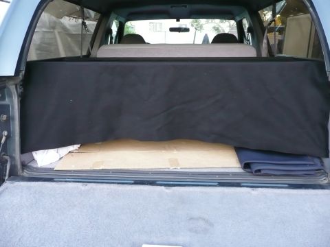 1991 Ford Bronco - Interior view of the cargo area in a 1991 Ford Bronco, showing a black cargo cover.