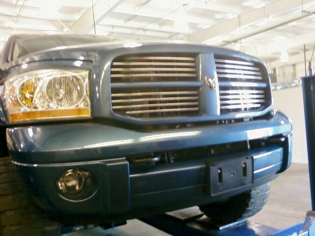 Front view of a blue 2006 Dodge 2500 pickup truck's grille and headlight assembly