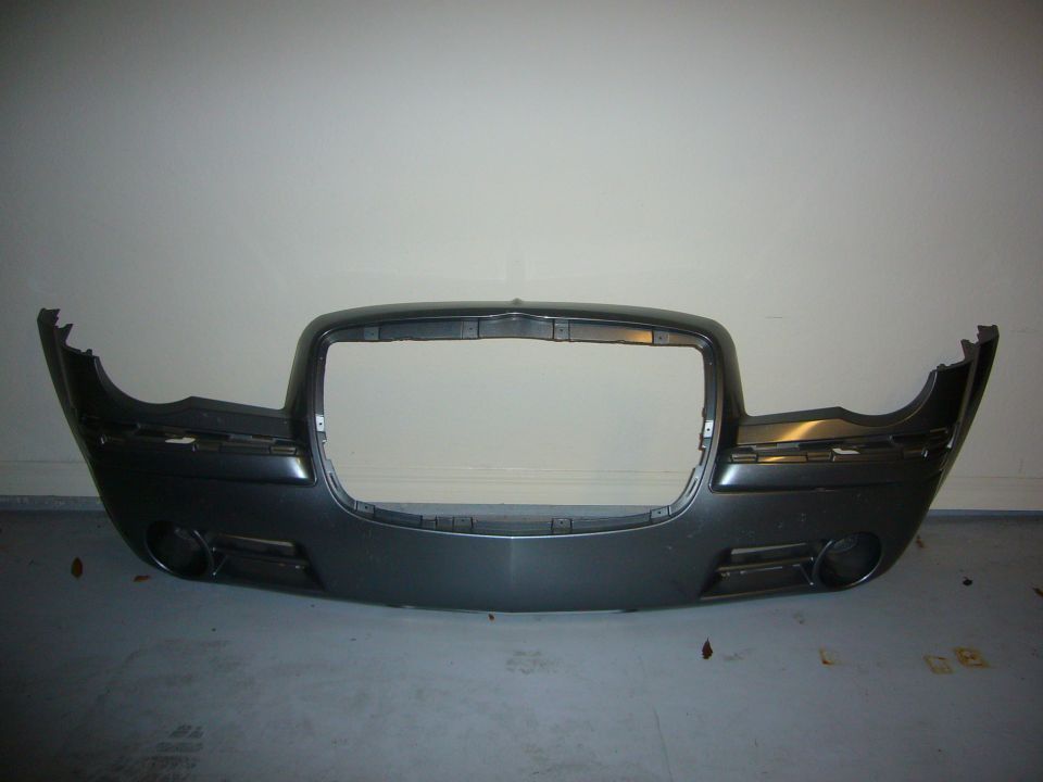 Dark gray Chrysler 300 front bumper with grille opening and fog light cutouts
