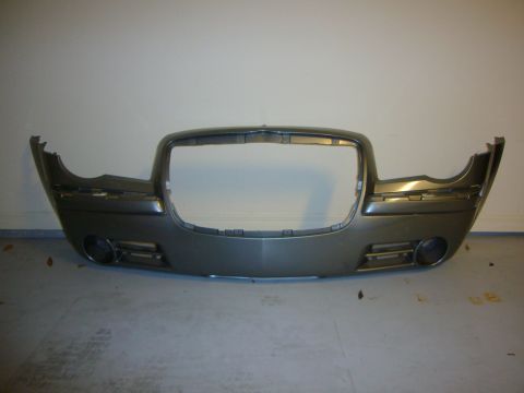 2007 Chrysler 300 - A detached front bumper assembly for a Chrysler 300, showing its grille opening and headlight housings.