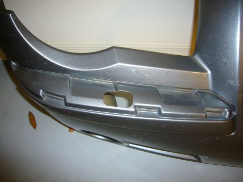 2007 Chrysler 300 - Close-up of a silver bumper section, likely for a Chrysler 300, showing mounting details.