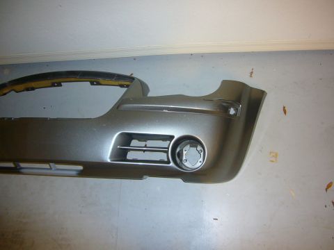 2007 Chrysler 300 - A silver car bumper is shown, detached from a vehicle, with a fog light housing and grille details visible.