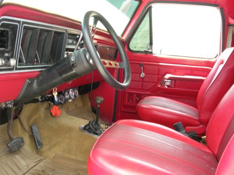 1978 Ford Bronco - Interior view of a 1978 Ford Bronco, showing red seats and dashboard details.