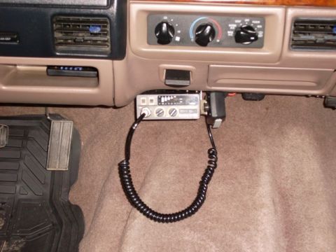 1996 Ford Bronco - A CB radio is installed below the dashboard, with its microphone attached.
