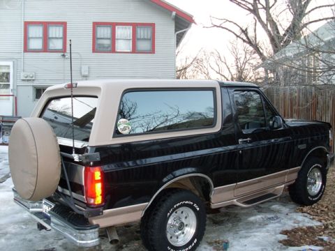 1996 Ford Bronco - This Ford Bronco is parked outside a house with snow on the ground.