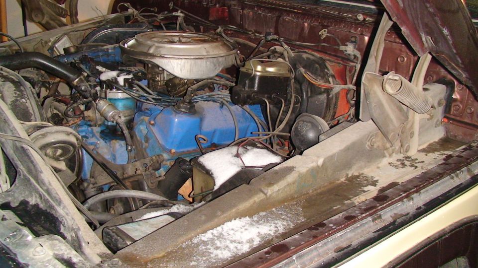 Blue Ford V8 engine bay with chrome air cleaner, snow on the inner fender