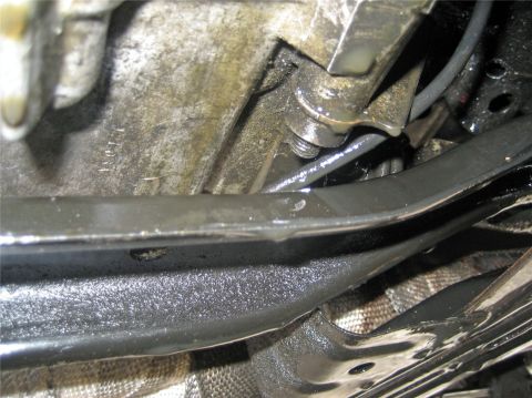 1993 Ford Probe - Close-up view of the underside of a vehicle, revealing oily mechanical parts and a visible website address for-sale website watermark.