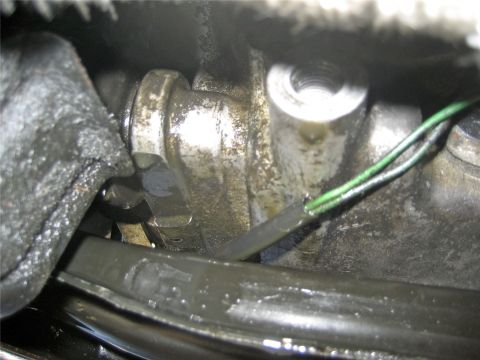 1993 Ford Probe - Close-up view of an engine component, showing green wires and signs of oil leakage.