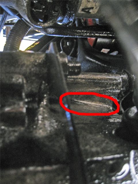 1993 Ford Probe - Cracked engine part highlighted with a red circle, showing damage.