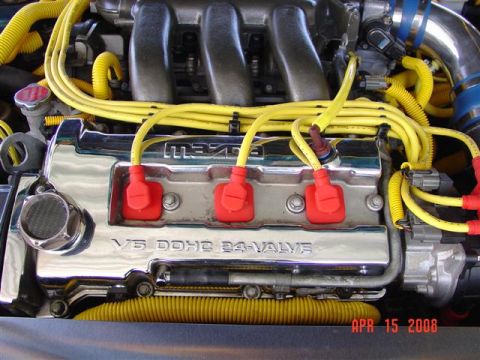 1993 Ford Probe - Close-up of a Mazda V6 engine bay, showing the valve cover and spark plug wires.