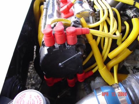 1993 Ford Probe - Close-up view of an engine's distributor cap and spark plug wires, with a date stamp visible in the corner.