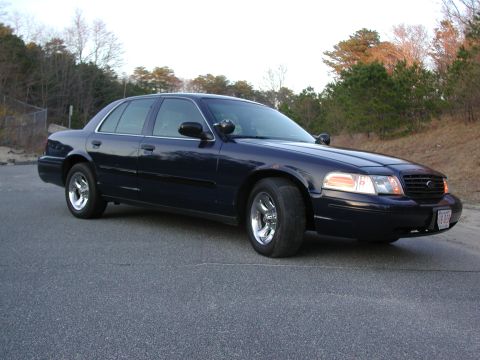 1999 Ford Crown Victoria - Dark blue Ford Crown Victoria seen from the front-right angle on a paved road.