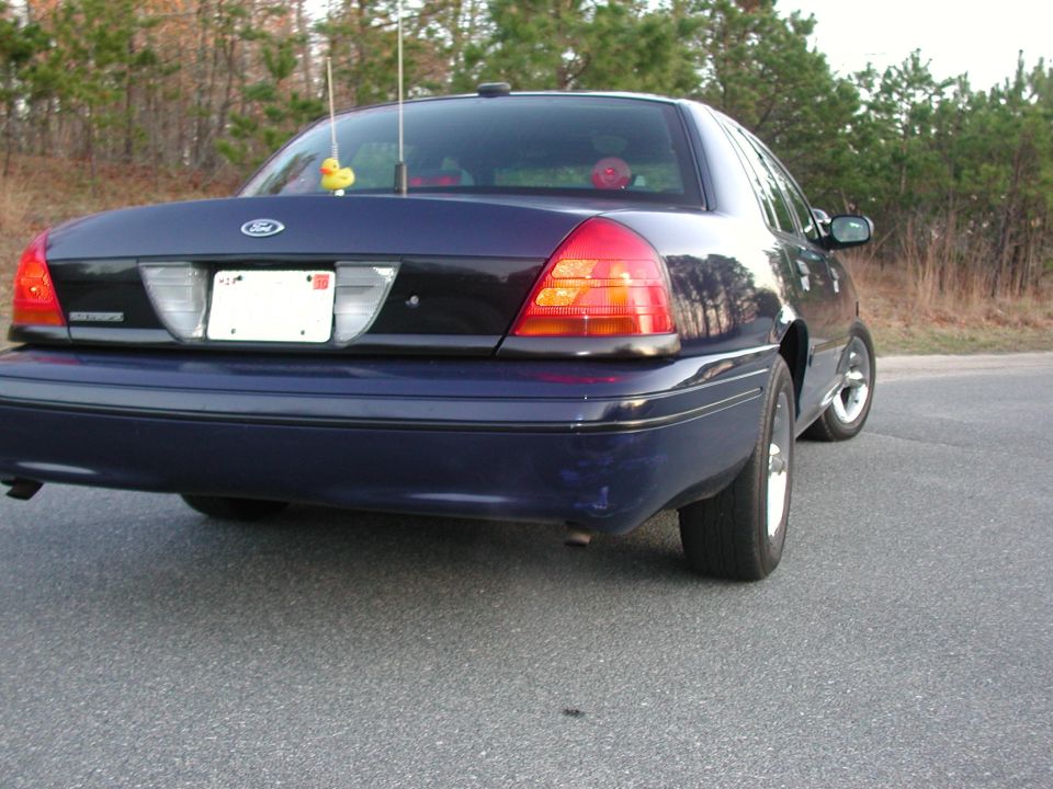 Rear view of a 1999 Ford Crown Victoria sedan, dark blue