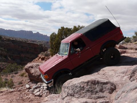 1990 Ford Bronco - This 1990 Ford Bronco navigates a challenging rock obstacle during an off-road event.