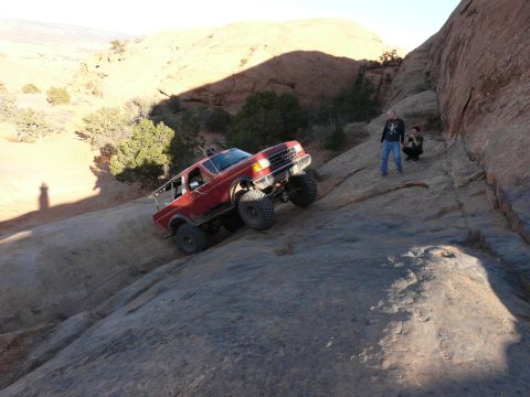 1990 Ford Bronco - A red 1990 Ford Bronco navigates a steep, rocky trail during the 2008 Easter Jeep Safari in Moab.