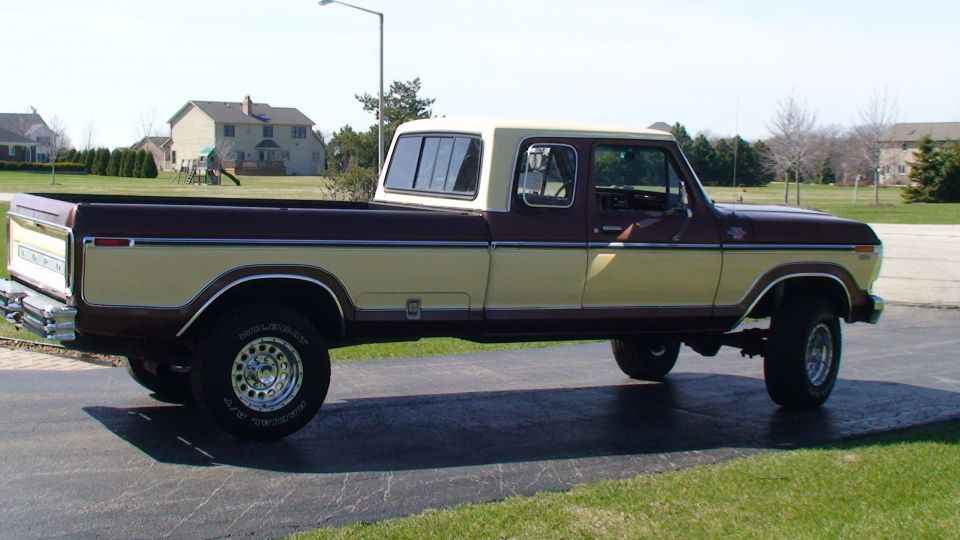 Side view of two-tone brown and cream Ford crew cab pickup on driveway